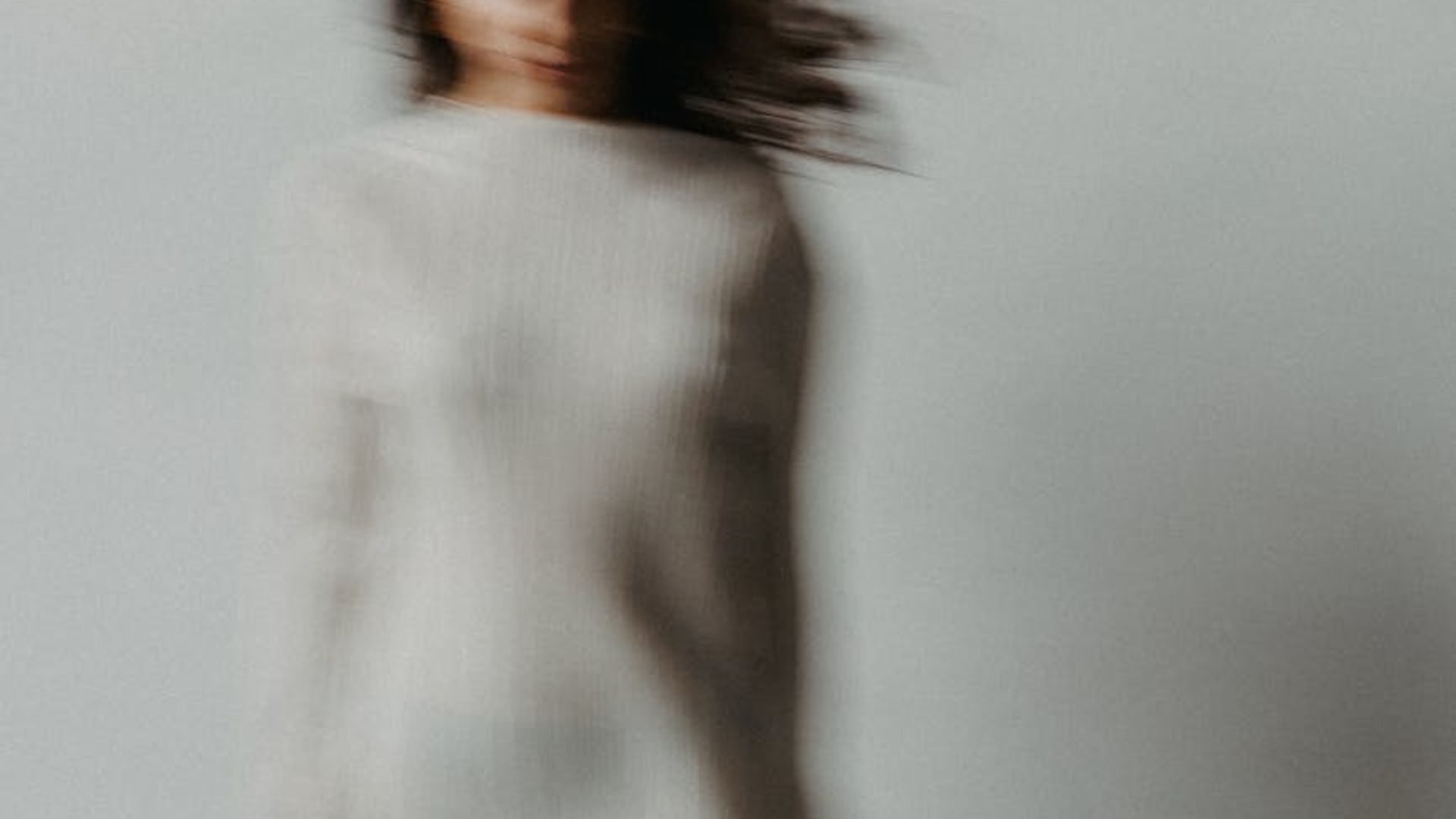 Abstract background with soft light trails suggesting focus and movement.