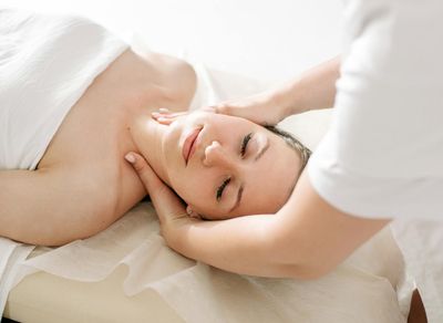 Close-up of a person's calm face with eyes closed, in a state of relaxation.
